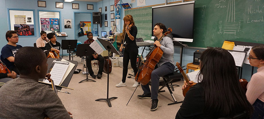 Nicola Benedetti and Alexei Grynyuk leading a master class for students at Celia Cruz Bronx High School for Music