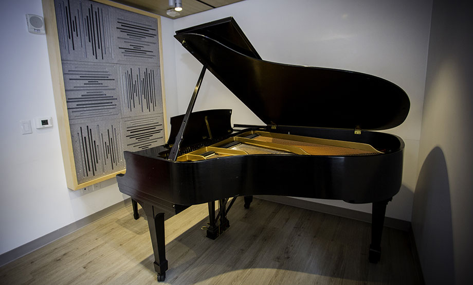 School of Music practice room with baby grand piano