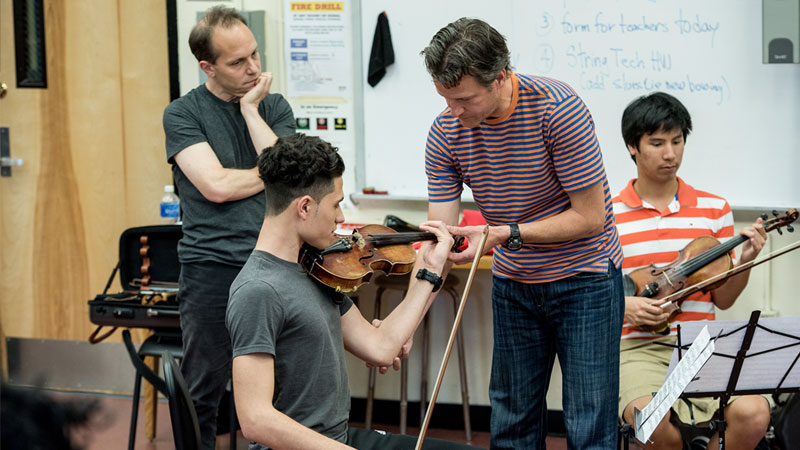 Geoff Nutall of the St Lawrence String Quartet coaching music students at Edward R. Murrow High School in Brooklyn